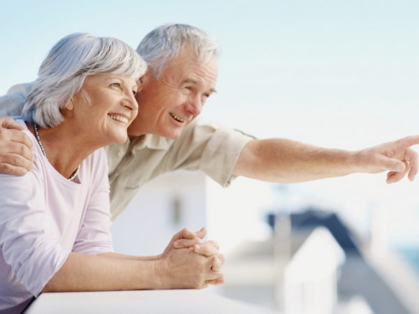 Senior man pointing out to something interesting to his wife